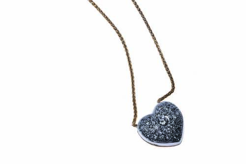 A diamond pendant, the pave diamond set heart-shaped pendant suspended from an extendable Italian gold chain. Estimated total diamond weight 0.42 carat. 9ct yellow and white gold. Weight 5.3grams. Length 50cm.