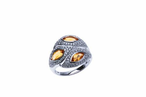 A citrine and diamond ring, the front section set with three marquise-shaped citrines and small brilliant cut diamonds. 9ct white gold. Weight 6.43 grams. Size O.