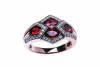 A diamond and garnet ring, the front section set with four oval garnets in a diamond set mount. 9ct rose gold. Weight 5.5 grams. Size P.