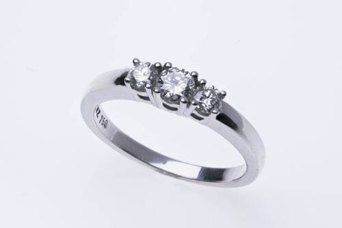 A diamond ring, set three across with graduated round modern brilliant cut diamonds of estimated total diamond weight 0.35 carat. 18ct white gold. Weight 4.54 grams. Size O.