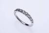 A diamond band ring, set nine across with round brilliant cut diamonds. Estimated diamond weight 0.18 carat. 18ct white gold. Weight 2.53 grams. Size N.
