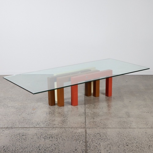 A Large Glass Coffee Table with Geometric Base