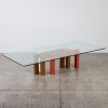 A Large Glass Coffee Table with Geometric Base