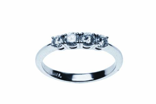 A diamond eternity ring, claw set with four modern brilliant cut diamonds of total estimated weight 0.56 carat. Palladium. Weight 2.10 grams. Size M.