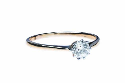 A solitaire diamond ring, claw set with an old European cut diamond of estimated weight 0.42 carat. 18ct yellow gold and platinum. Weight 2 grams. Size P.