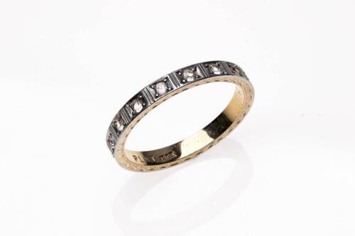 A white sapphire eternity ring, set all around with round brilliant sapphires. 18ct yellow gold and platinum. Weight 4 grams.