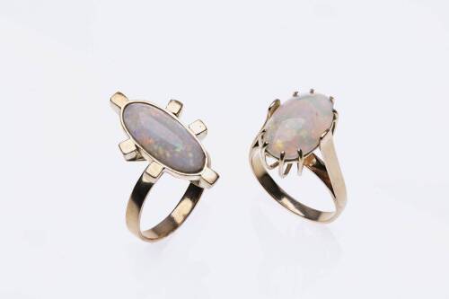 Two opal rings, each set with a solid oval white opal cabochon. 18ct yellow gold. Weight 17.3 grams. Sizes T and U.