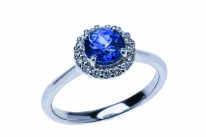 A Ceylonese sapphire and diamond ring, the central blue sapphire of known weight 1.31 carats, in a diamond set frame. Diamonds of total known weight 0.15 carat. 18ct white gold. Weight 4.60 grams. Size N½.