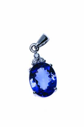 A Tanzanite and diamond pendant, the oval Tanzanite of estimated weight 2.62 carats surmounted by three modern brilliant diamonds of estimated total weight 0.05 carat. 18ct white gold. Weight 2.26 grams. Length 20mm.  