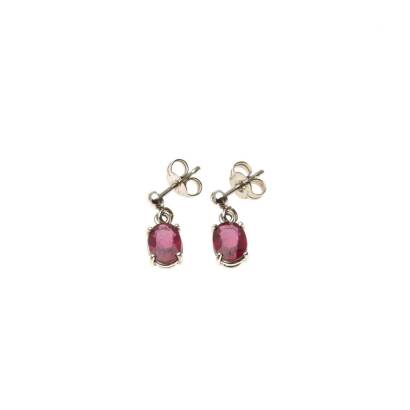 A pair of ruby drop earrings, each four claw set with a treated oval ruby. 18ct white gold. Weight 1.8 grams. Post and butterfly attachments.