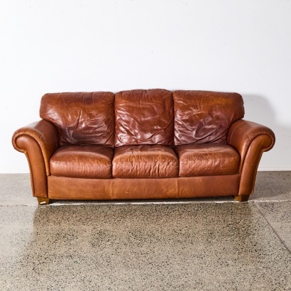 A Three Seater Sofa In Brown Leather