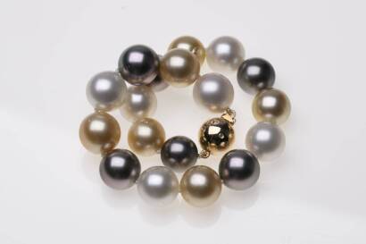 A South Sea and Tahitian pearl bracelet, the eighteen round and alternating white, golden and black pearls measuring 10 - 11mm, hung with a diamond set plain polished 18ct yellow gold ball clasp. Length 21cm.