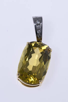 A golden beryl and diamond pendant enhancer, four claw set with an oval beryl of known weight 10 carats, with a diamond set bale. 18ct yellow and white gold. Weight 6.83 grams. Length 29mm.