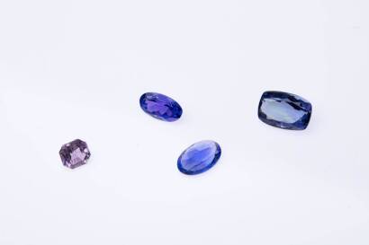 A parcel of 4 loose gemstones, comprising an oval facetted tanzanite of known weight 1.47 carats; an oval facetted tanzanite of known weight 1.50 carats; a rectangular facetted tanzanite of known weight 3.18 carats;&nbsp;and one square step cut pink sapphire o