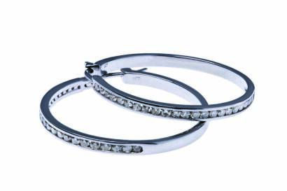 A pair of diamond hoop earrings, the front section channel set with round brilliant diamonds of known total weight 1 carat. 9ct white gold. Weight 8.05 grams.&nbsp;Diameter 32mm.&nbsp;