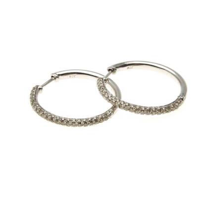 A pair of diamond hoop earrings, the front section pave set with round brilliant diamonds of known total weight 1 carat. 9ct white gold. Diameter 25mm. Weight 4.67 grams.&nbsp;