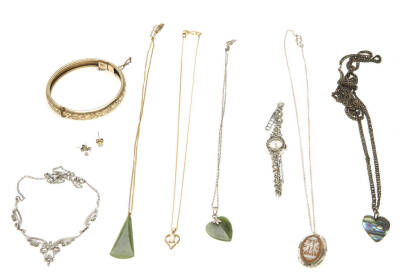 An assortment of costume jewellery including greenstone pendant, marcasite watch and necklace.