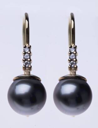 A pair of Tahitian pearl and diamond drop earrings, the 9.5mm round pearls each surmounted by a line of three round brilliant cut diamonds. 9ct yellow gold. Weight 4.37 grams. Hook attachments. Length 26mm. 