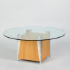 A Circular Glass Coffee Table with Block Base