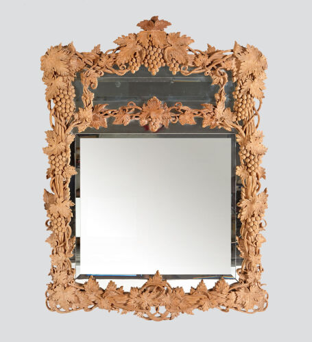 An Elaborately Carved Wooden Framed Mirror 