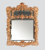 An Elaborately Carved Wooden Framed Mirror 