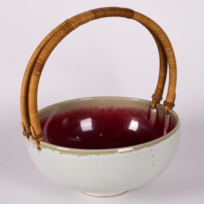 A Large Ceramic Bowl With Cane Handle