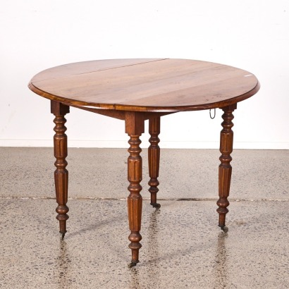 An Antique French Drop Leaf Table
