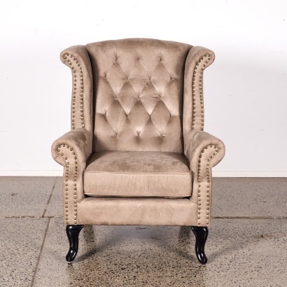 A Wingback Library Chair With Gold Upholstery Buttons