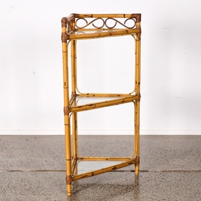 A Three Tier Glass Shelved Cane Corner Unit