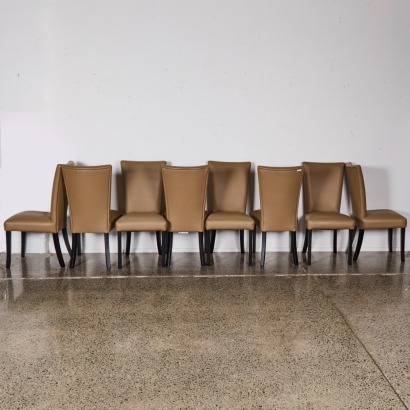 A Set of Eight Beige Vinyl Dining Chairs