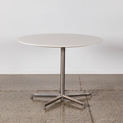 An Eames Style Circular Table With Stainless Base