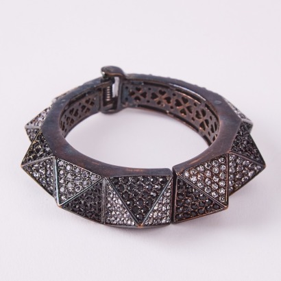 A Black Glass And Metal Hinged Cuff Bracelet With Stones