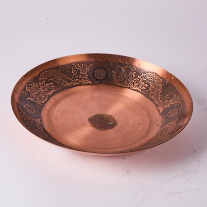 A Copper Toned Bowl with Dragon Designs