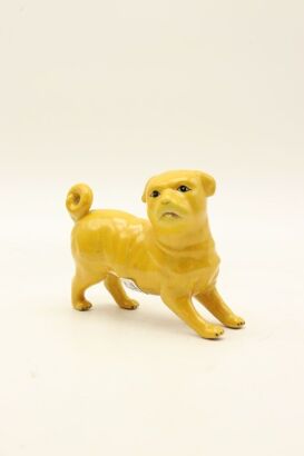 A Japanese mid-19th century Kutani-yaki yellow-glazed dog ornament