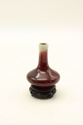 A Chinese Res-glazed Bottle Vase (with Original Stand)