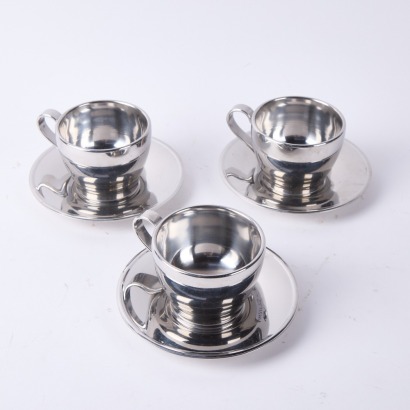 A Trio of Italian Stainless Steel Cups and Saucers