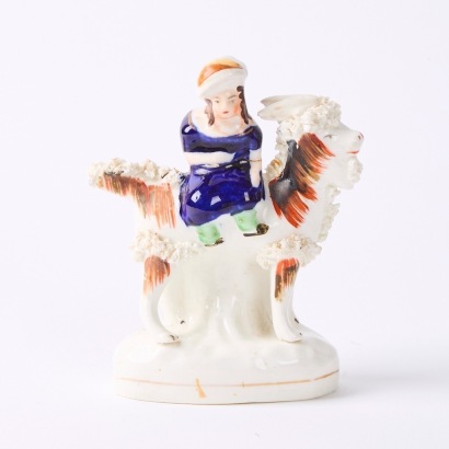 A Staffordshire Pottery Girl Riding a Goat