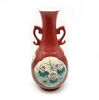 A Chinese Red Ground Famille Rose Vase decorated with panels