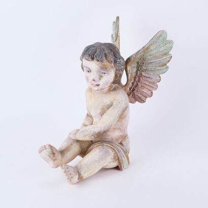 A Painted Cherub Figure