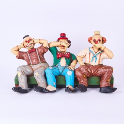 A Trio of Seated Clown Figurines