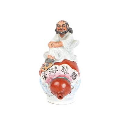 A Sumida Pottery Export Ornamental Figure of a European Man Sitting on Top of a Saki Gourd