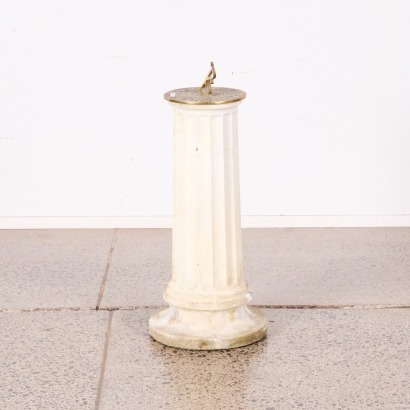 A Brass Sundial With A Concrete Base