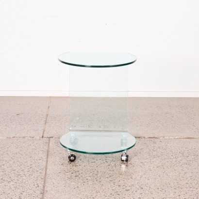 A Formed Glass Side Table On Castors