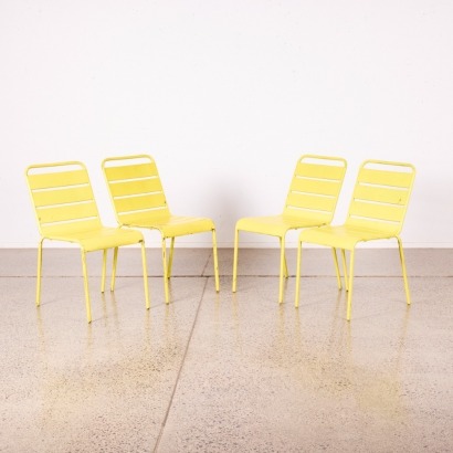A Set of Four Yellow Industrial Metal Chairs