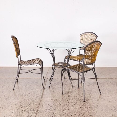 A Bistro Table And Three Chairs