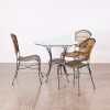 A Bistro Table And Three Chairs
