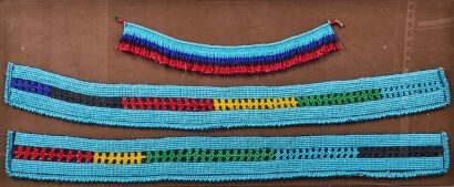 A Vintage Museum Display Case Of Three Beaded Belts