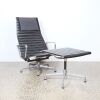 An Aluminium Lounge Chair Ea 124 & Ottoman Ea 125 By Charles & Ray Eames For Vitra