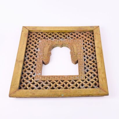 A Carved Wood and Brass Frame