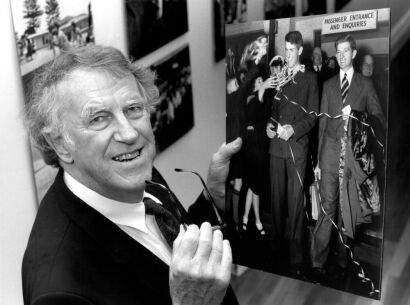 Sir Edmund Hillary Holds a Photograph of 1953 conquest of Mt Everest